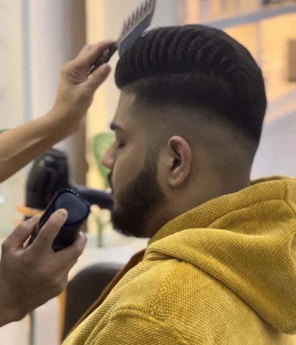 A man cutting hair in volume professional salon