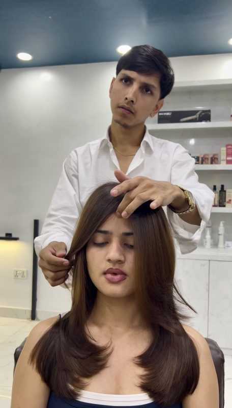 a boy is coloring a girl hair